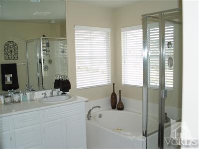 2093 Ribera Drive Oxnard, CA 93030 - Photo 7 of 9 a bathroom with a bathtub and a sink