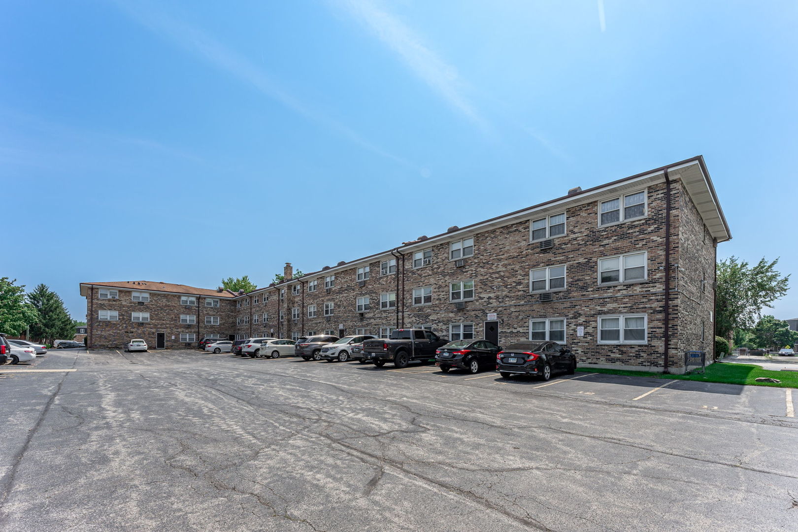 7100 99th Street, Unit 204 Chicago Ridge, IL 60415 - Photo 18 of 18 a car parked in front of a building