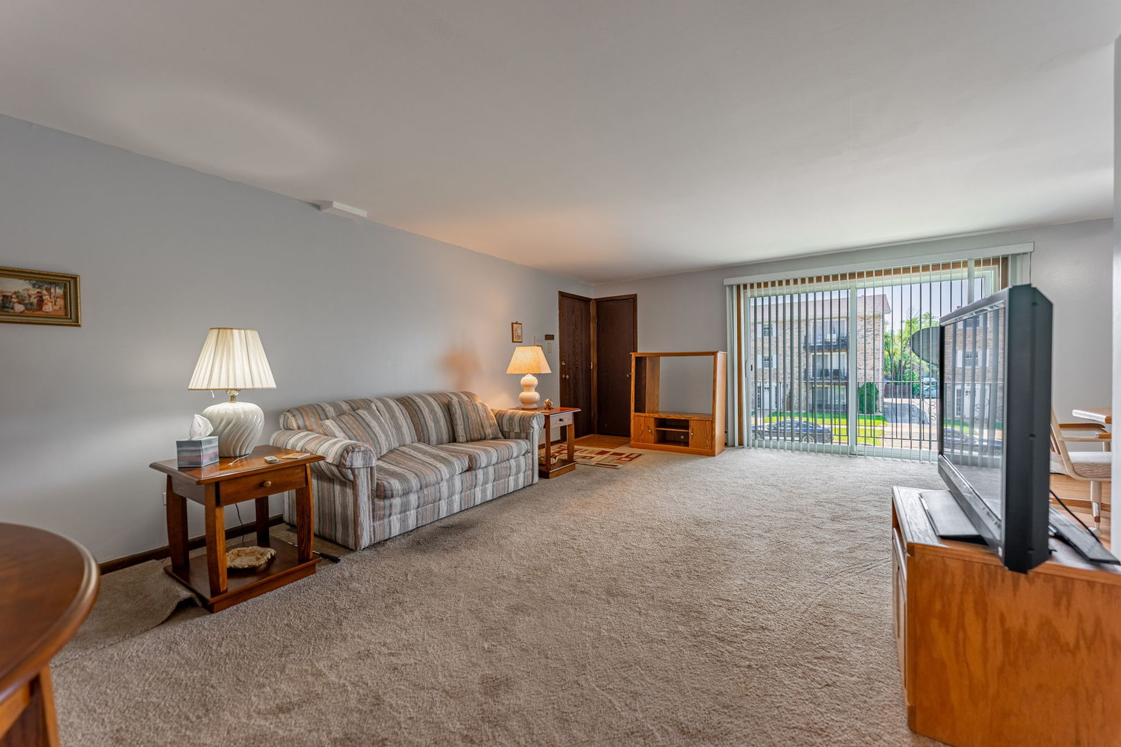 7100 99th Street, Unit 204 Chicago Ridge, IL 60415 - Photo 3 of 18 a living room with furniture and a large window