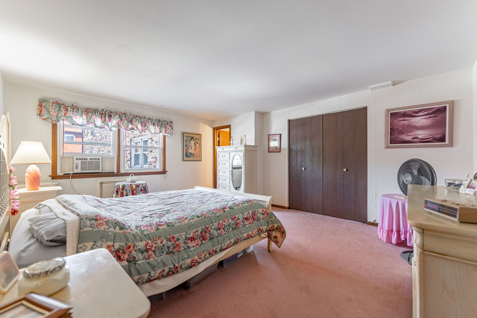 7100 99th Street, Unit 204 Chicago Ridge, IL 60415 - Photo 9 of 18 a bedroom with a bed and dresser with mirror