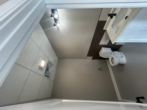 a bathroom with a sink mirror and toilet