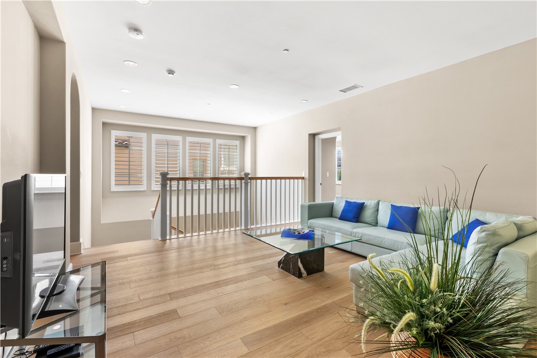 57 Harrison Irvine, CA 92618 - Photo 21 of 28 a living room with furniture a wooden floor and a flat screen tv