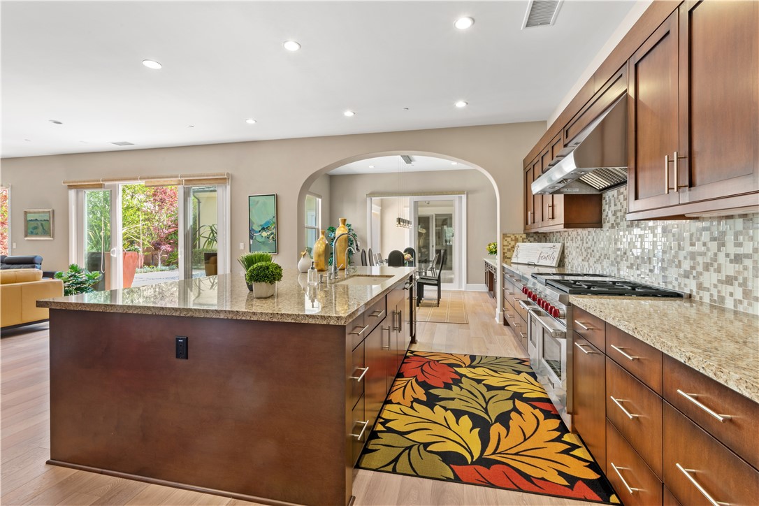 57 Harrison Irvine, CA 92618 - Photo 4 of 28 a large kitchen with stainless steel appliances granite countertop a large window and a sink