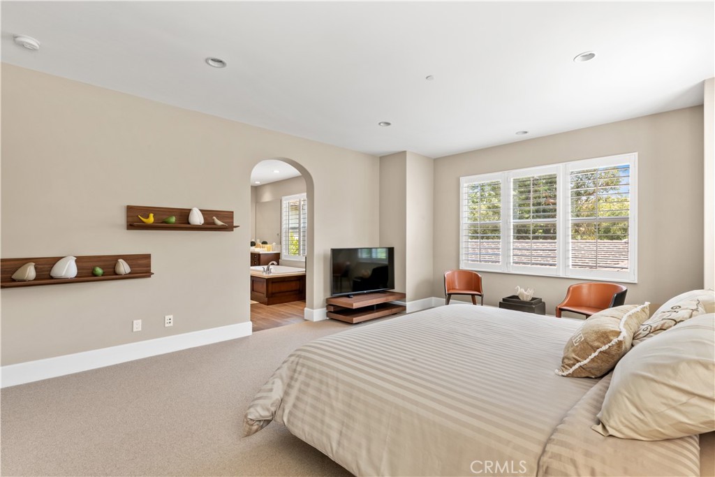 57 Harrison Irvine, CA 92618 - Photo 9 of 28 a bedroom with a large bed and a tv on the dresser