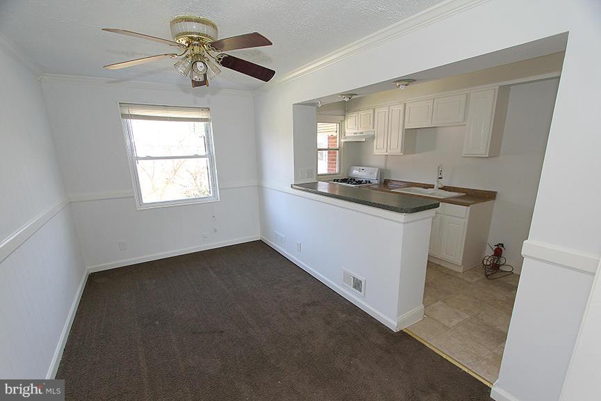 7436 Manchester Road Dundalk, MD 21222 - Photo 3 of 16 a kitchen with stainless steel appliances granite countertop a stove a sink and a refrigerator