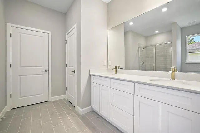 a bathroom with a double vanity sink and a mirror