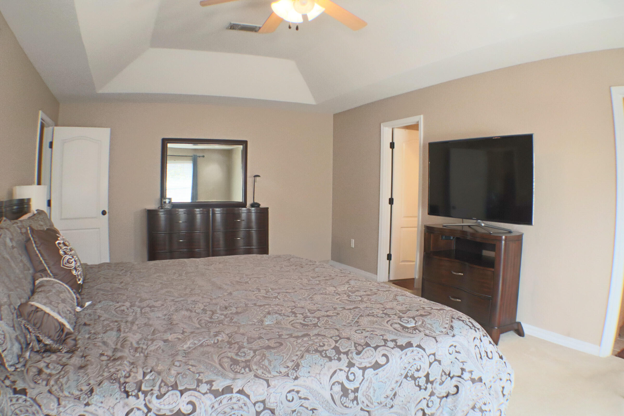 564 East Shipwreck Road Santa Rosa Beach, FL 32459 - Photo 15 of 38 a bedroom with a bed and a flat screen tv