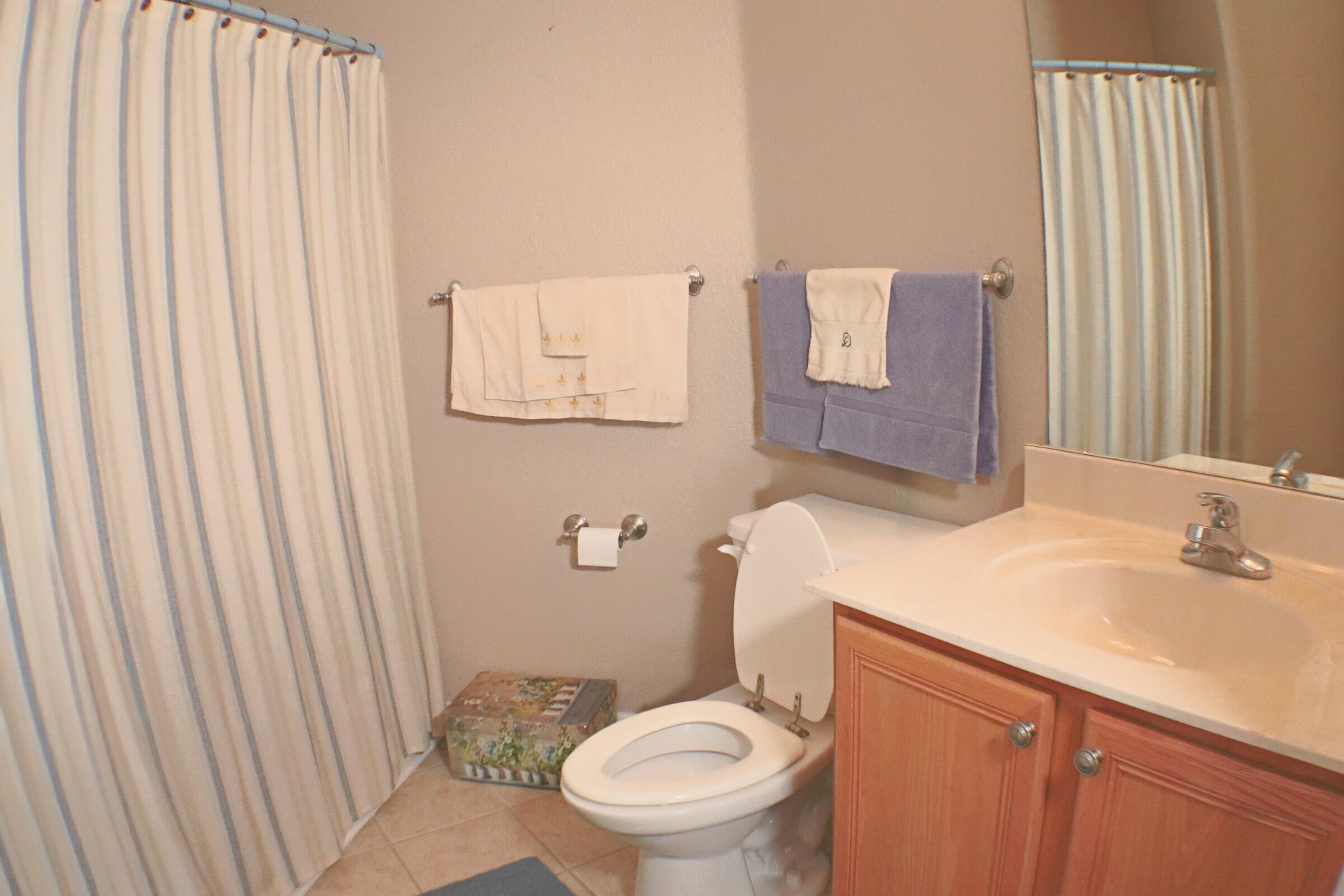 564 East Shipwreck Road Santa Rosa Beach, FL 32459 - Photo 24 of 38 a bathroom with a sink a toilet and shower curtain