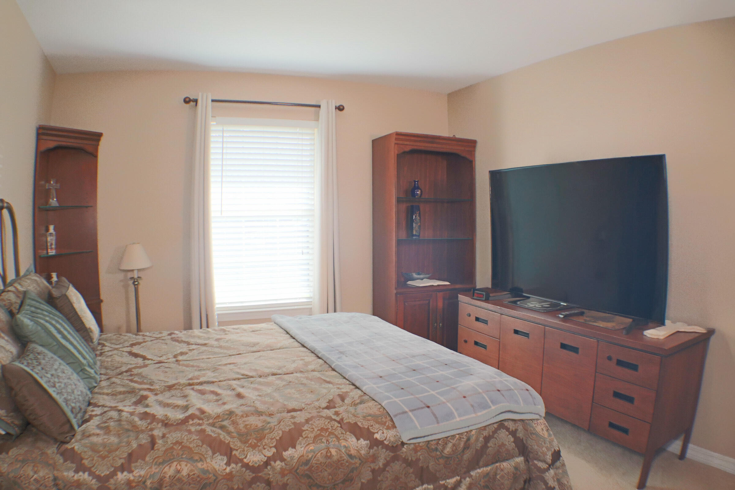 564 East Shipwreck Road Santa Rosa Beach, FL 32459 - Photo 26 of 38 a bedroom with a bed and a flat tv screen on dresser