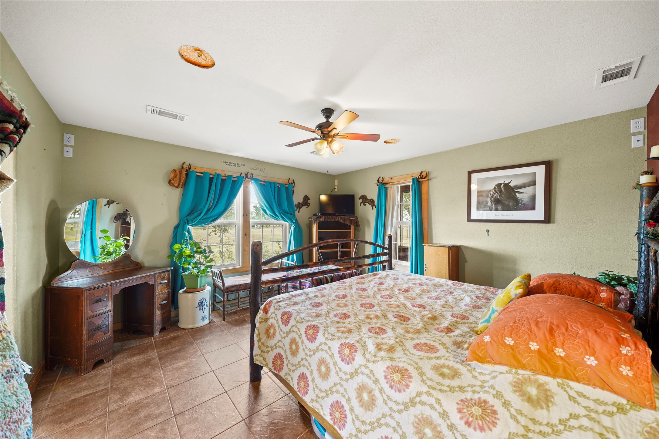 6710 Boothline Road Richmond, TX 77469 - Photo 19 of 43 a bedroom with a bed and a chandelier