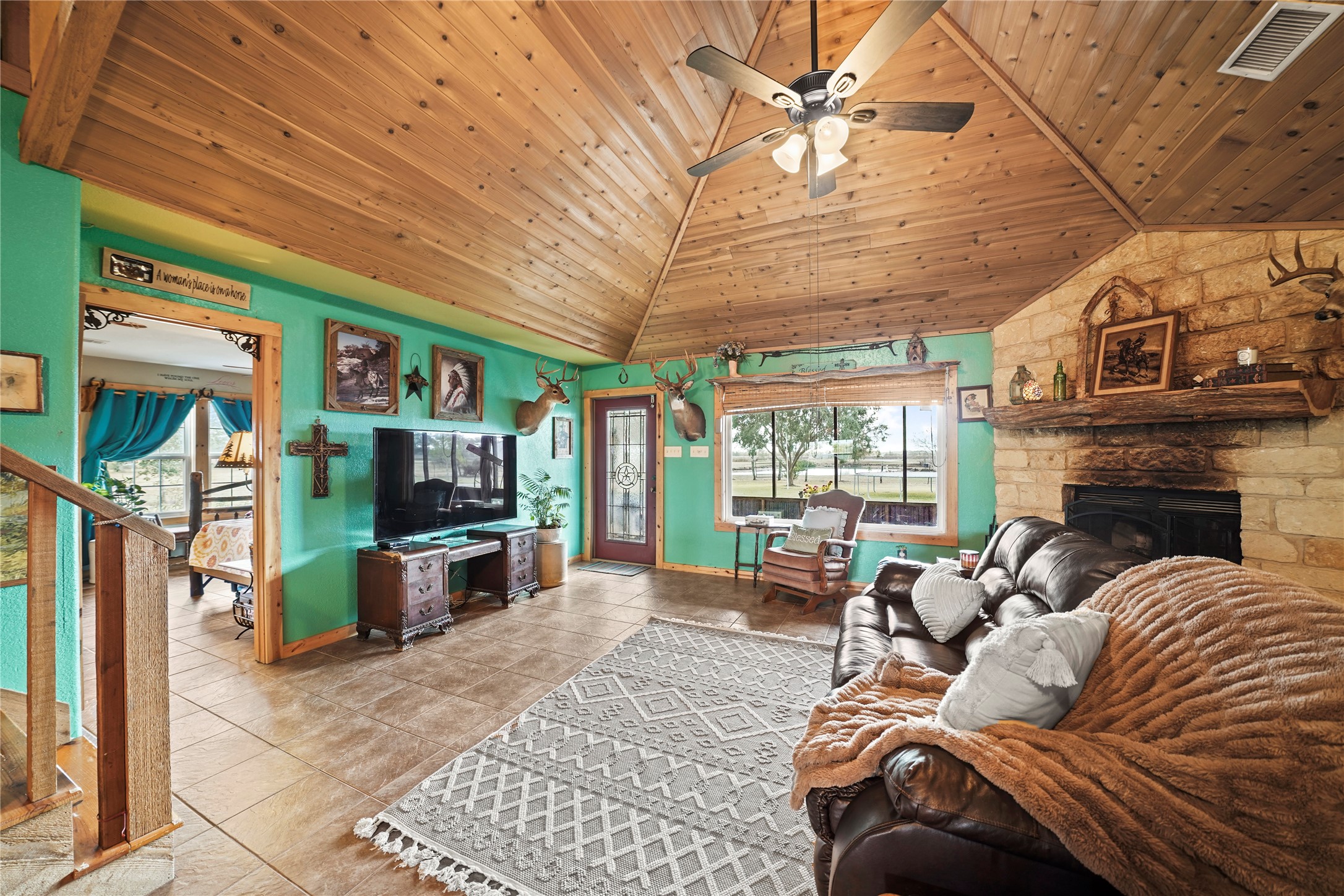 6710 Boothline Road Richmond, TX 77469 - Photo 10 of 43 a living room with furniture a flat screen tv and a fireplace