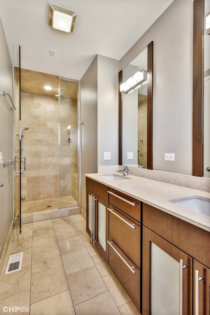 1331 North Mohawk Street, Unit 3 Chicago, IL 60610 - Photo 13 of 28 a spacious bathroom with a granite countertop sink mirror and shower