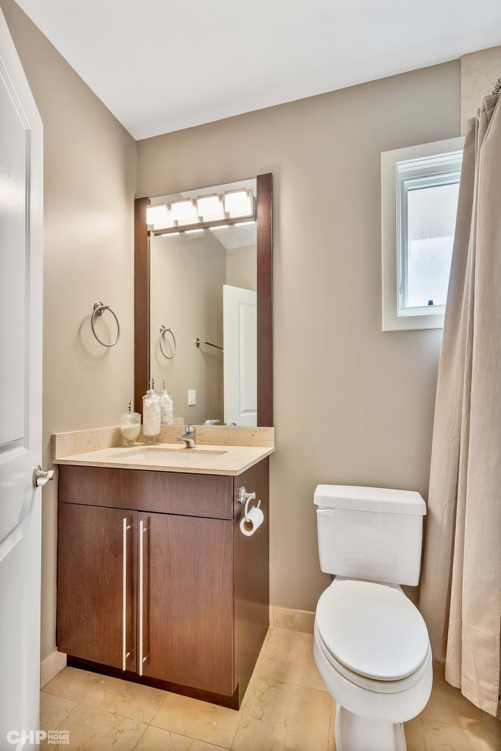 1331 North Mohawk Street, Unit 3 Chicago, IL 60610 - Photo 18 of 28 a bathroom with a toilet a sink and mirror