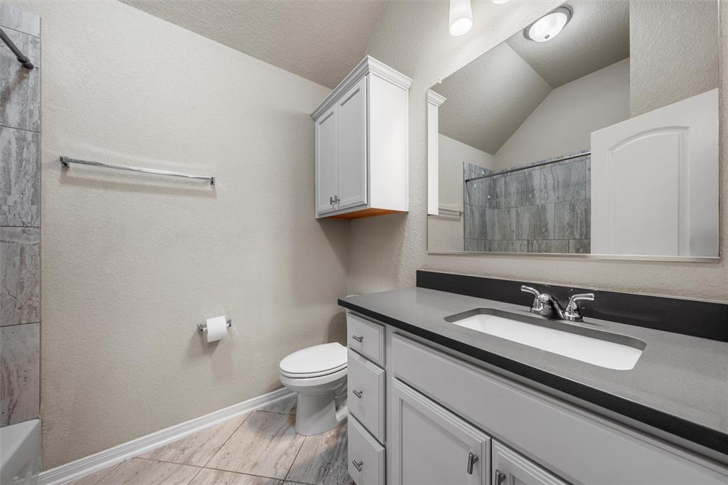 11308 Gulch Drive Lorena, TX 76655 - Photo 28 of 40 a bathroom with a sink a toilet and a mirror