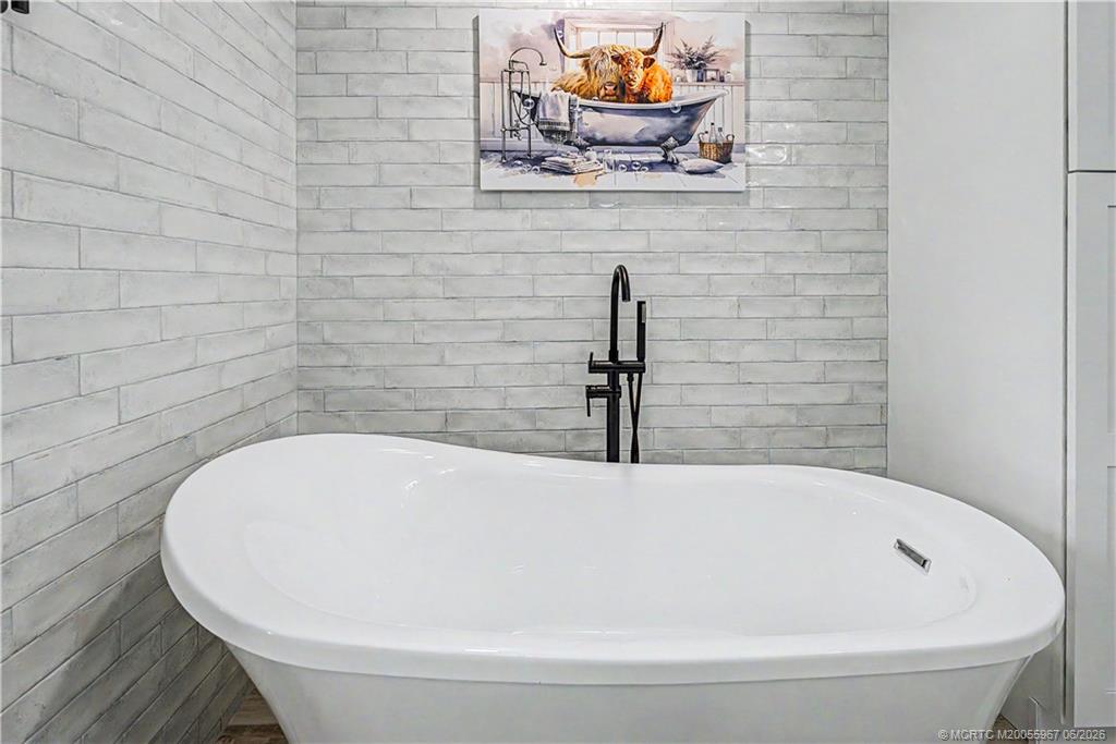 8200 Southwest Springhaven Avenue Indiantown, FL 34956 - Photo 26 of 35 a white bath tub sitting in a bathroom