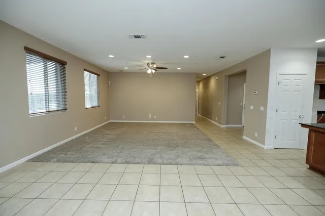 a large kitchen with a large counter top stainless steel appliances and cabinets