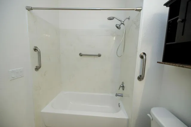 an empty room with a window and a ceiling fan