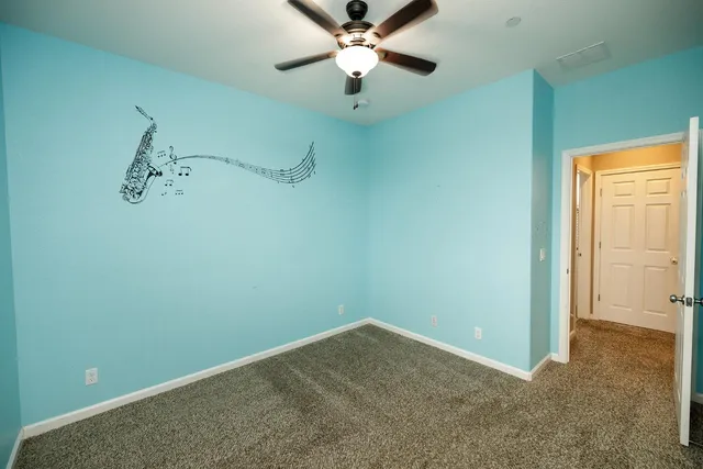 a spacious bathroom with a tub sink and mirror