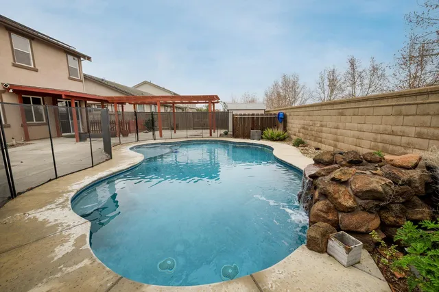 a front view of a house with a garden and garage