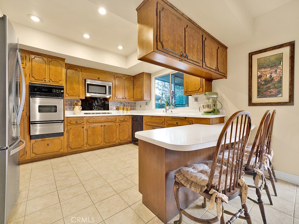 5092 Berkeley Avenue Westminster, CA 92683 - Photo 9 of 39 a kitchen with cabinets and chairs