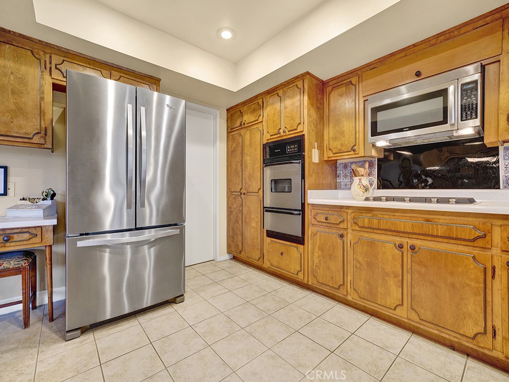 5092 Berkeley Avenue Westminster, CA 92683 - Photo 13 of 39 a kitchen with stainless steel appliances a refrigerator sink and microwave