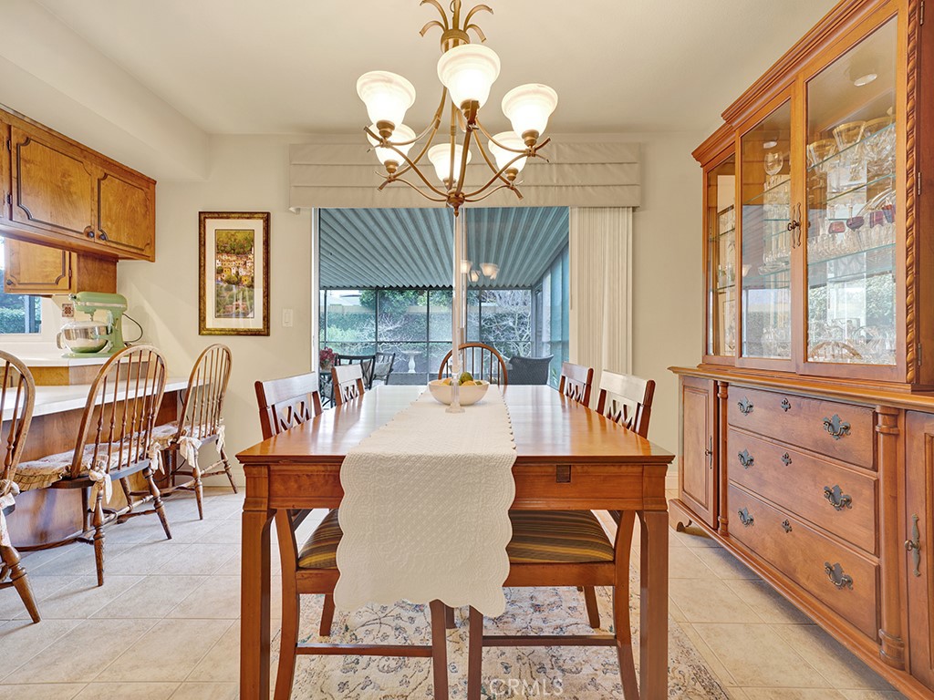 5092 Berkeley Avenue Westminster, CA 92683 - Photo 15 of 39 a view of a dining room with furniture a chandelier and wooden floor