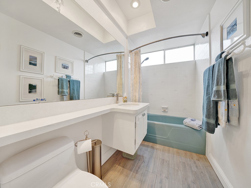 5092 Berkeley Avenue Westminster, CA 92683 - Photo 27 of 39 a bathroom with a sink and a large mirror