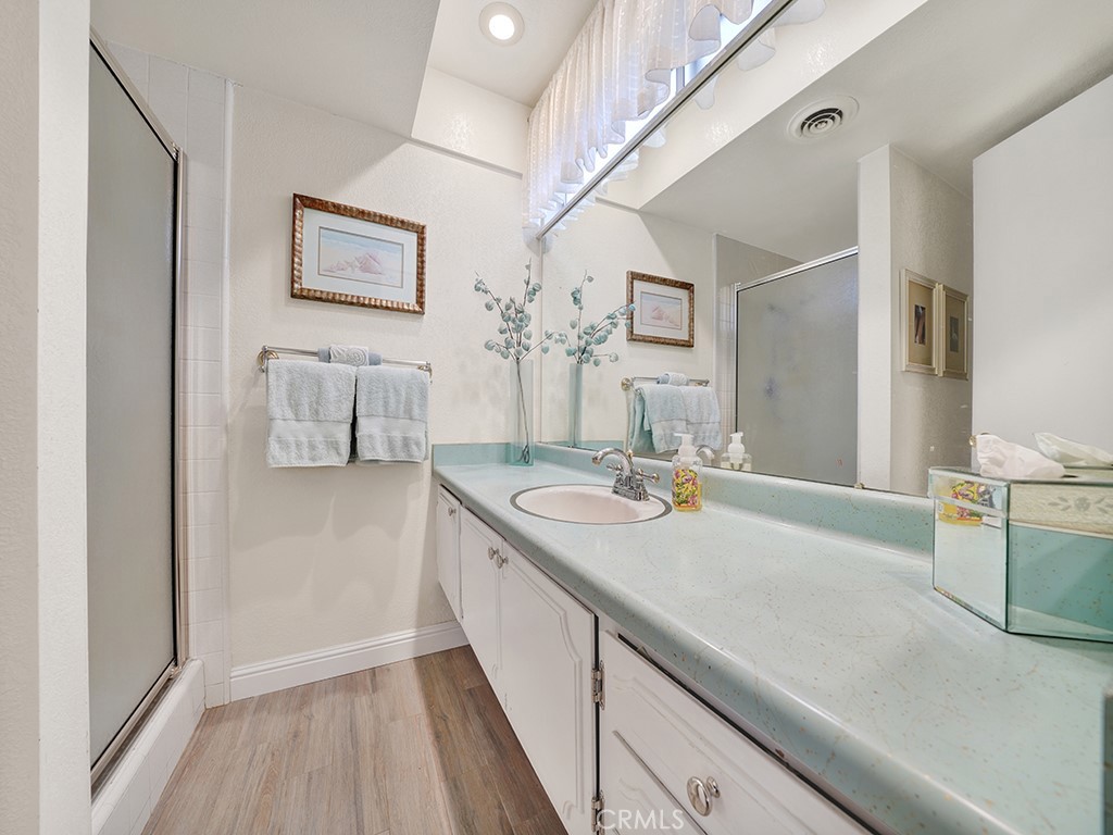 5092 Berkeley Avenue Westminster, CA 92683 - Photo 34 of 39 a en suite bathroom with a granite countertop sink and a mirror