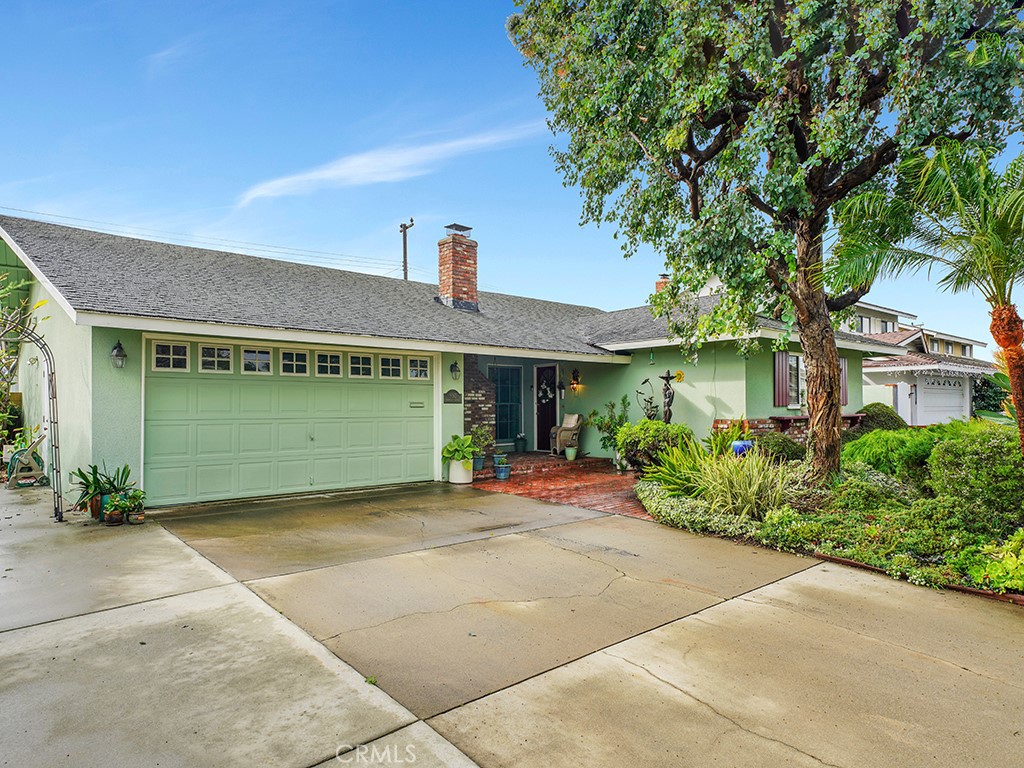 5092 Berkeley Avenue Westminster, CA 92683 - Photo 37 of 39 a front view of a house with a yard and potted plants