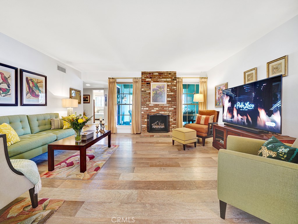 5092 Berkeley Avenue Westminster, CA 92683 - Photo 2 of 39 a living room with furniture a fireplace and a flat screen tv