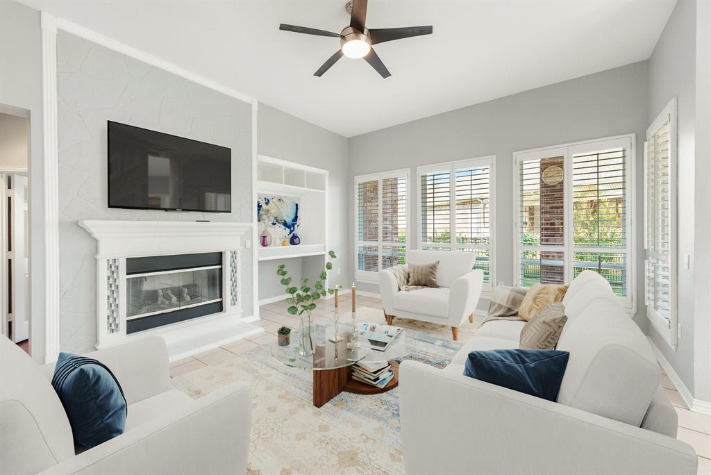 a living room with furniture fireplace and flat screen tv