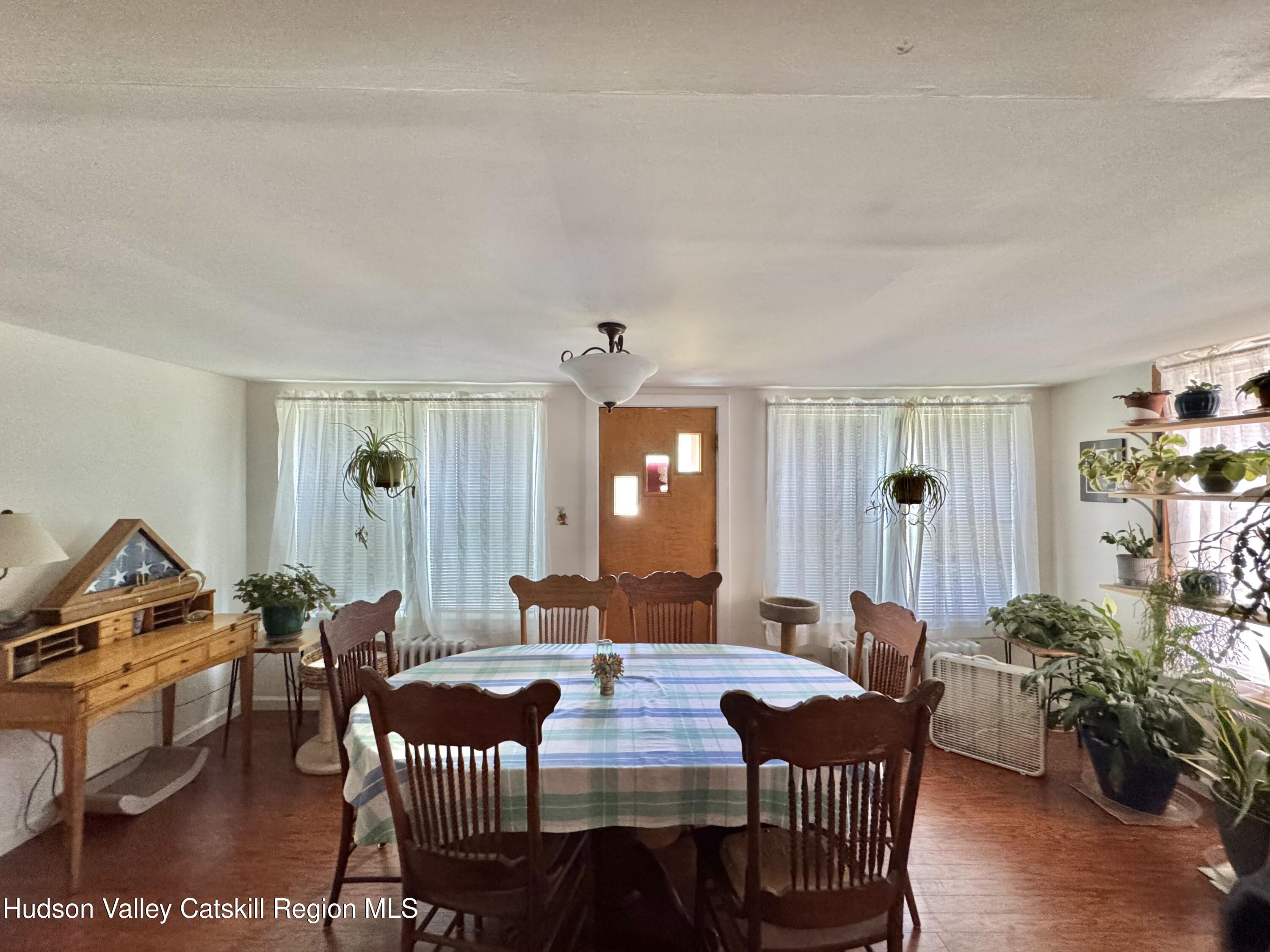 189-195 Vedder Road Catskill, NY 12414 - Photo 12 of 39 a view of a dining room with furniture and wooden floor