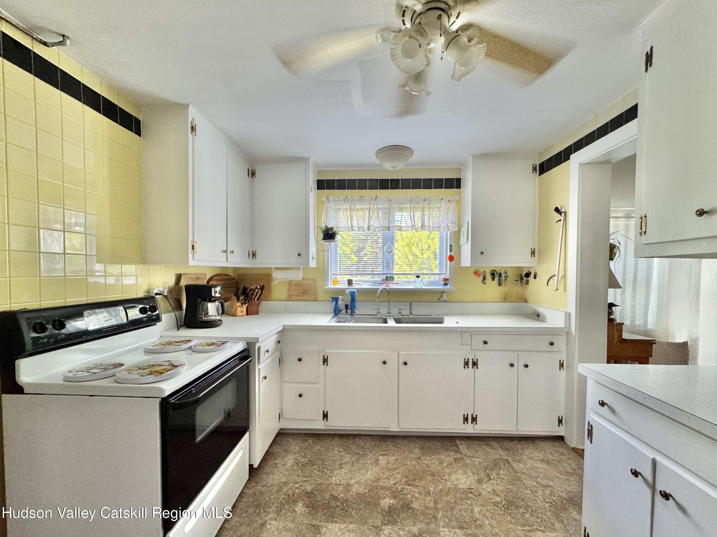 189-195 Vedder Road Catskill, NY 12414 - Photo 13 of 39 a kitchen with granite countertop a sink appliances cabinets and a large window