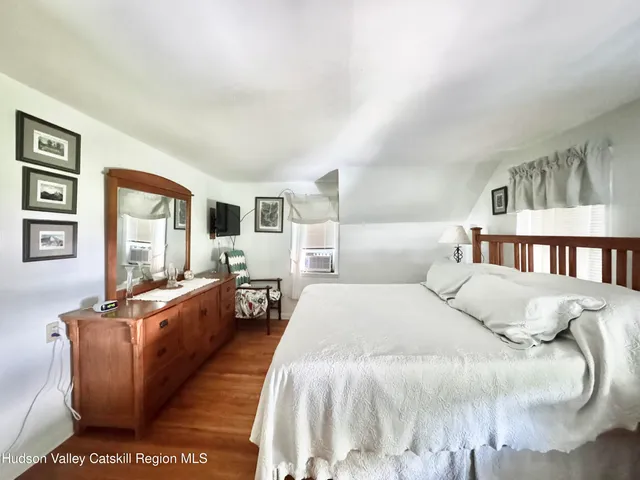 a bed room with a bed and a large window