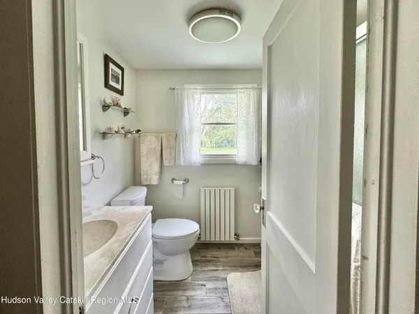 a bathroom with a toilet a sink and a mirror