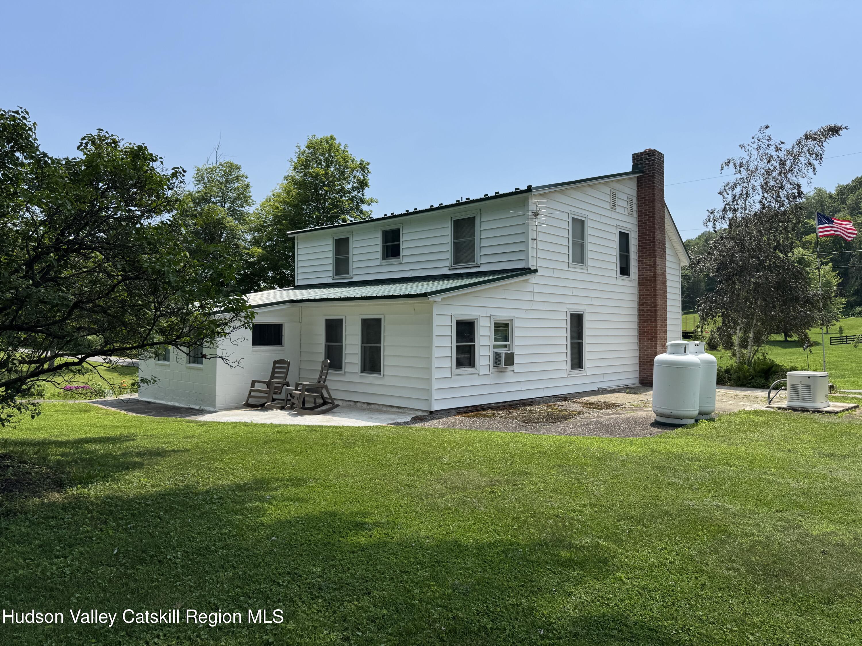 189-195 Vedder Road Catskill, NY 12414 - Photo 23 of 39 a front view of a house with a yard and garage
