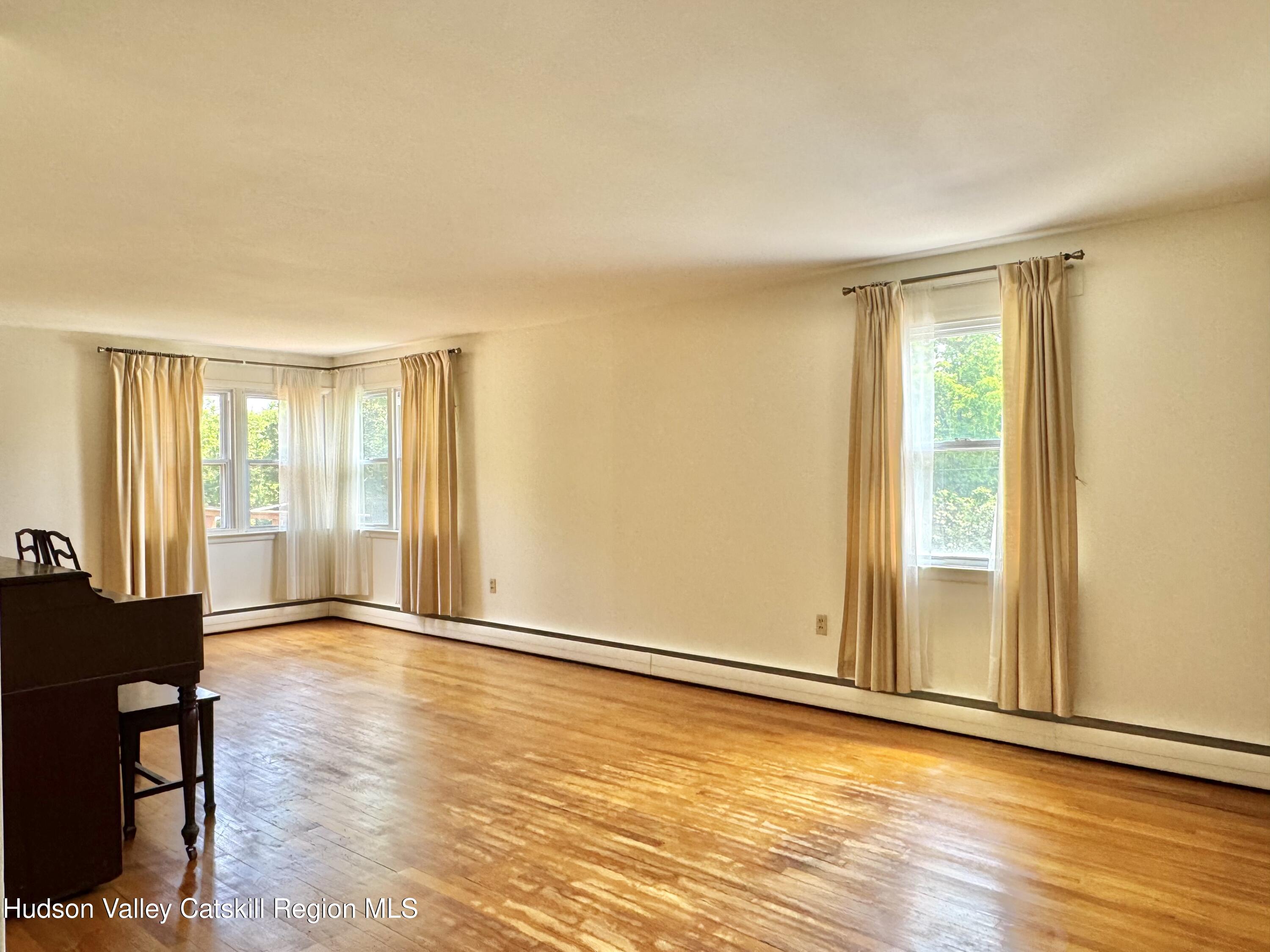 189-195 Vedder Road Catskill, NY 12414 - Photo 26 of 39 a view of an empty room with wooden floor and a window