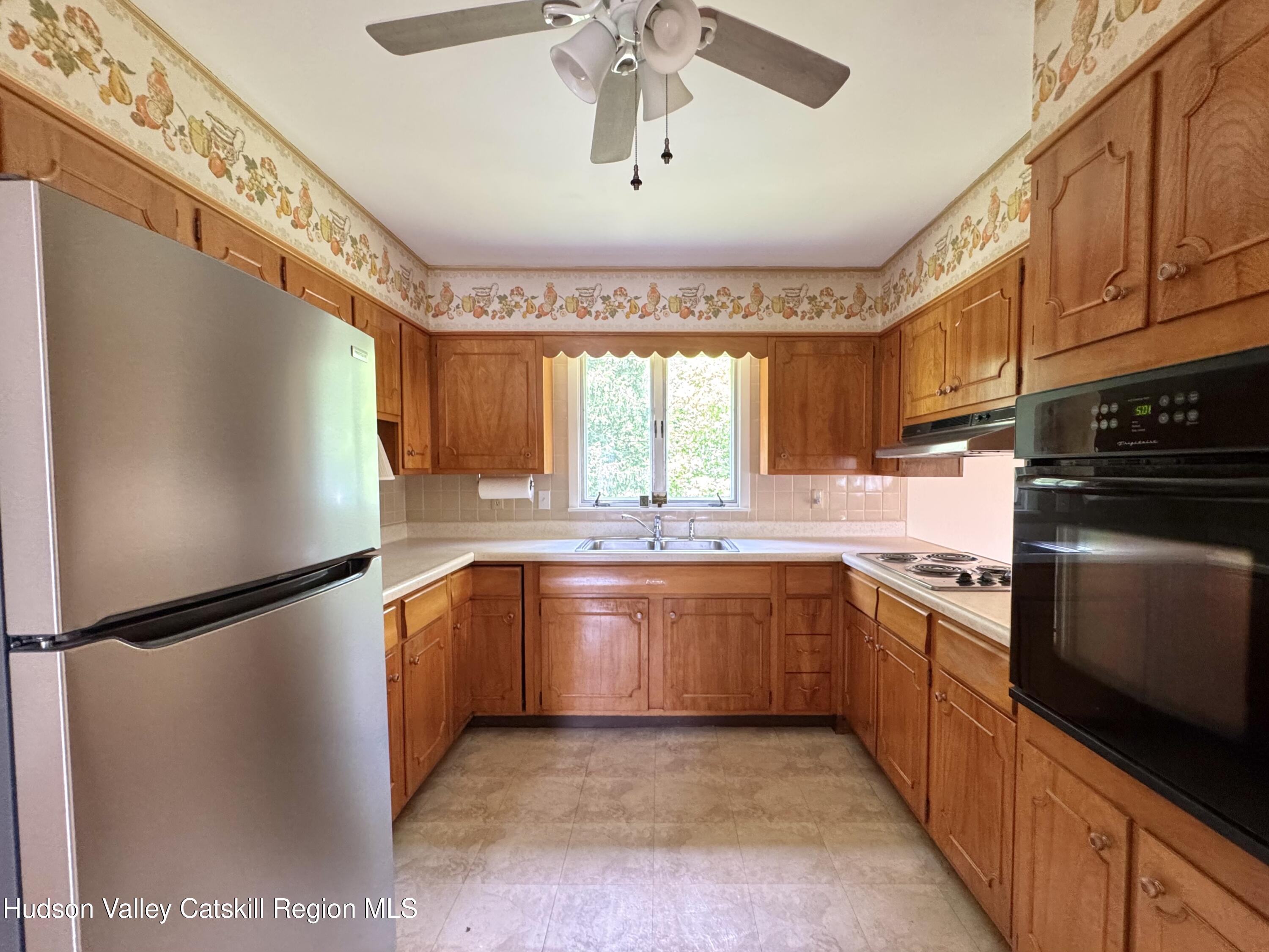 189-195 Vedder Road Catskill, NY 12414 - Photo 28 of 39 a kitchen with stainless steel appliances granite countertop a refrigerator a sink dishwasher a stove and white cabinets with wooden floor