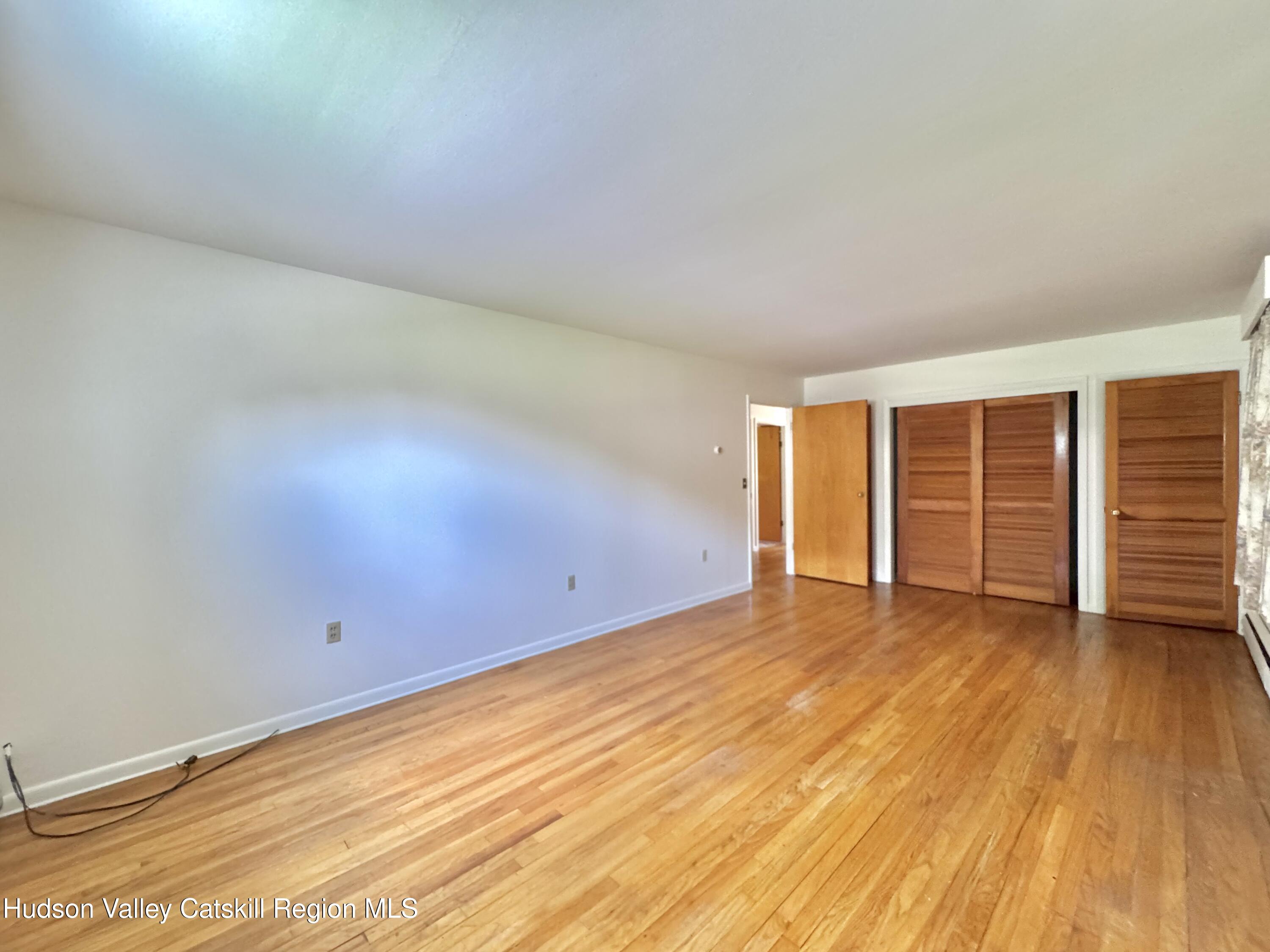 189-195 Vedder Road Catskill, NY 12414 - Photo 30 of 39 an empty room with wooden floor and windows