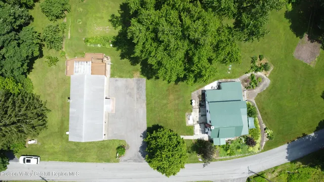 an aerial view of a house with a yard