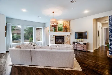 a living room with furniture fireplace and flat screen tv