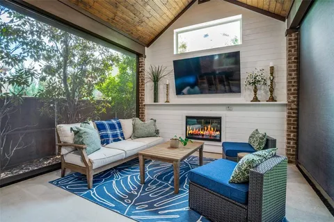 a outdoor living space with furniture and a fireplace