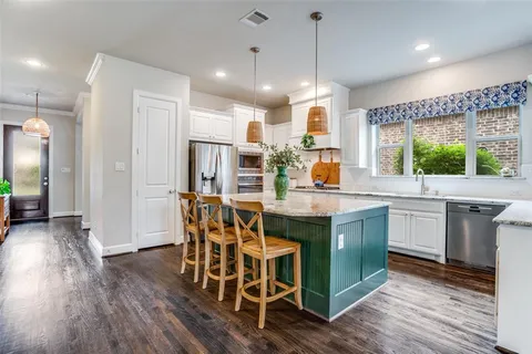 a kitchen with a table and chairs in it