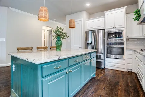 a kitchen with stainless steel appliances a sink stove and refrigerator