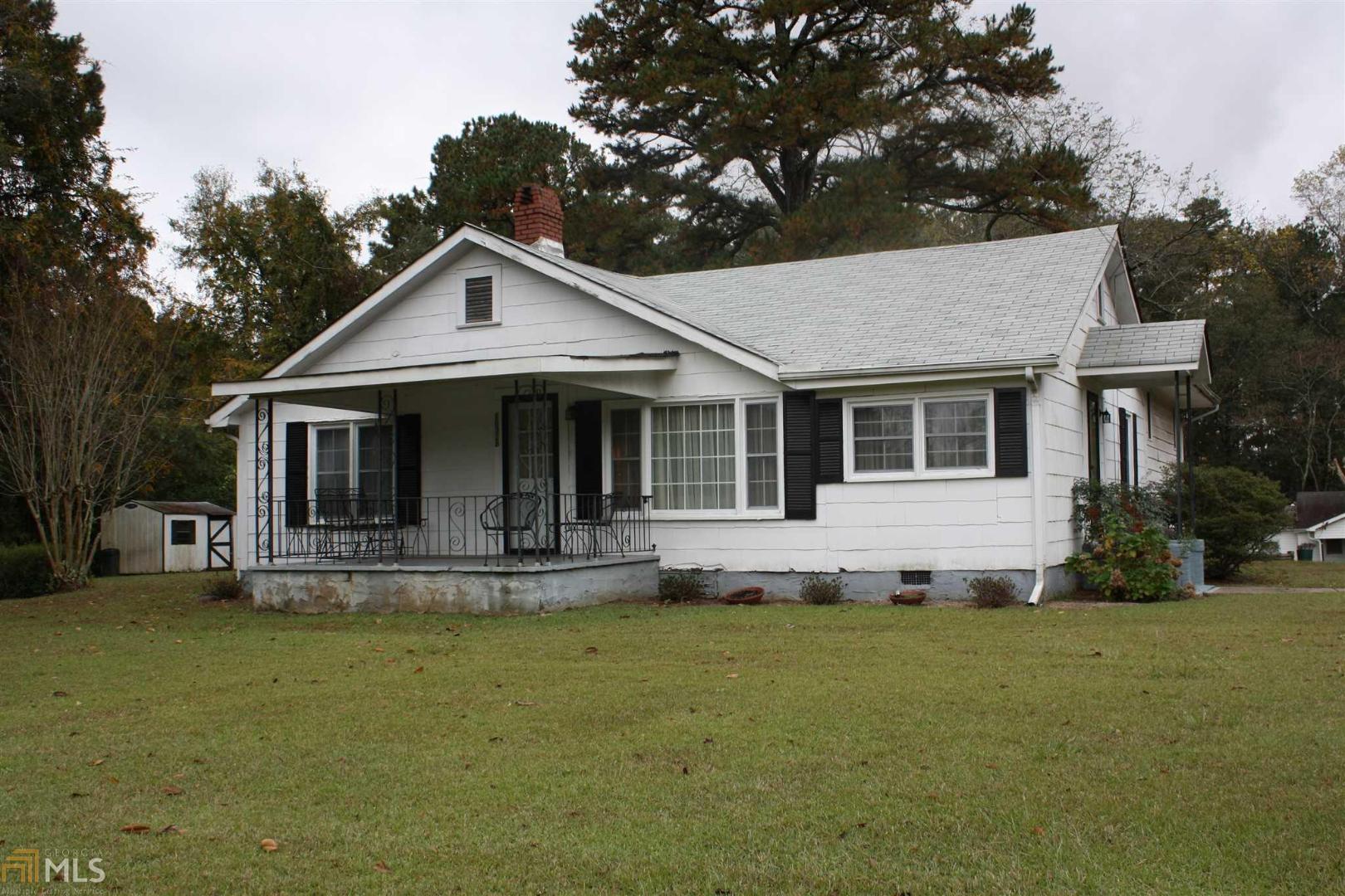 10328 Flat Shoals Road Covington, GA 30014 - Photo 1 of 1 a front view of a house with a yard
