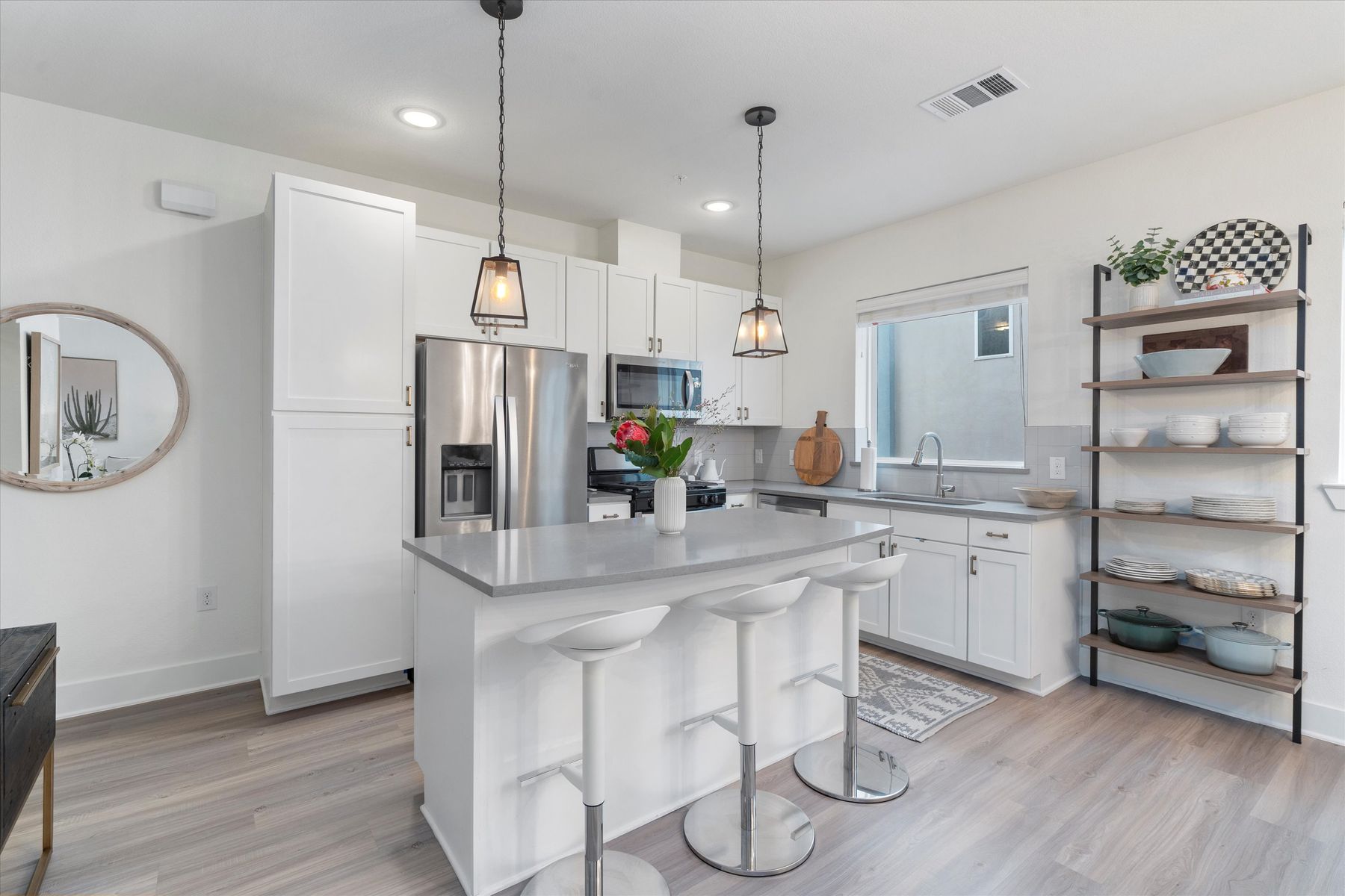 2827 Manor Road, Unit 3102 Austin, TX 78722 - Photo 5 of 18 A well-lit kitchen boasts a central island with bar seating, integrated sink, and modern stainless steel appliances.