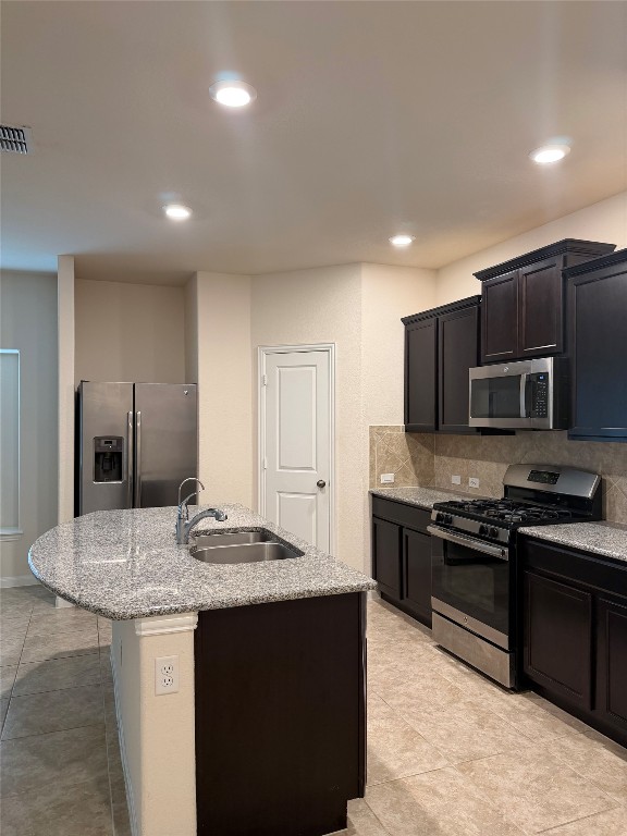 369 Shale Circle Buda, TX 78610 - Photo 2 of 15 a kitchen with stainless steel appliances granite countertop a sink stove and refrigerator