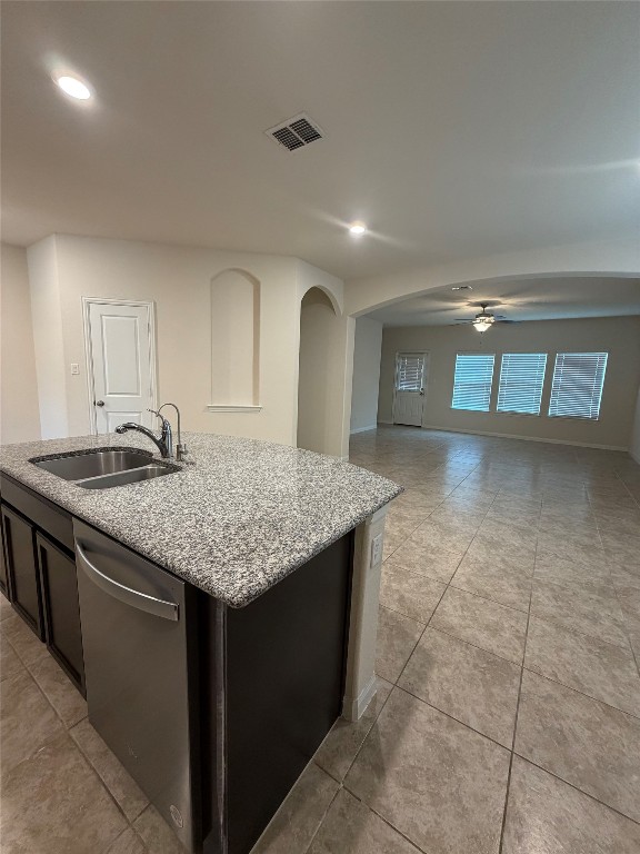 369 Shale Circle Buda, TX 78610 - Photo 5 of 15 a kitchen with granite countertop a sink a stove and cabinets