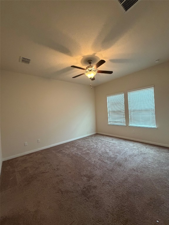 369 Shale Circle Buda, TX 78610 - Photo 7 of 15 an empty room with windows and chandelier fan