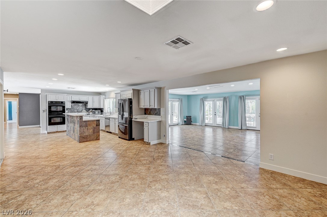 4153 Woodcrest Road Las Vegas, NV 89121 - Photo 57 of 58 An open floorplan seamlessly connects the well-appointed kitchen to a versatile living space.